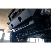 Black Jeep Wrangler JL/JT front bumper sway bar disconnect skid plate close up.