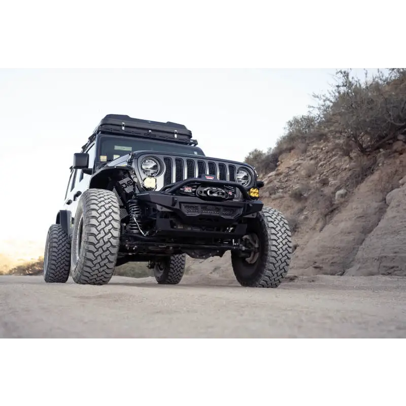 DV8 Offroad Spec Series Front Bumper on Jeep parked on dirt road
