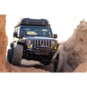 Jeep driving through rocky terrain on DV8 Offroad Spec Series Front Bumper for Wrangler JL Gladiator.