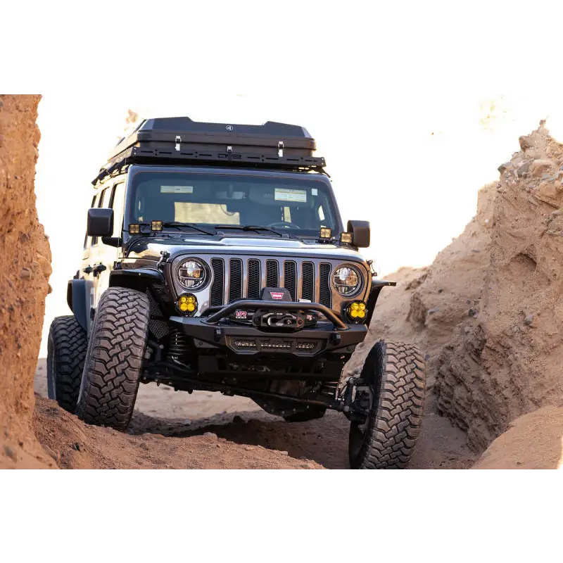 Jeep driving through rocky terrain on DV8 Offroad Spec Series Front Bumper for Wrangler JL Gladiator.