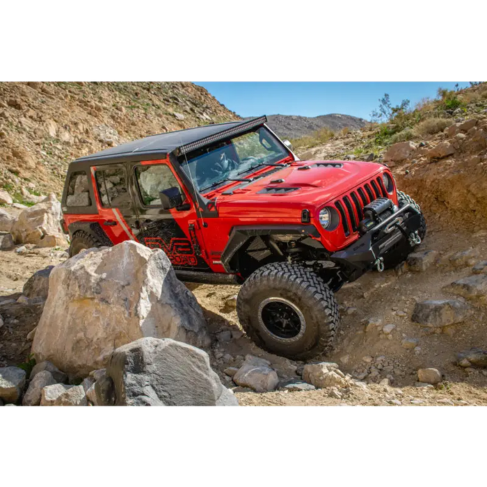 Jeep driving through rocky terrain with Rubicon Replica Hood.