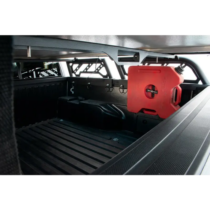 Red canister in truck bed on DV8 Offroad bed rack for Toyota Tacoma overland.