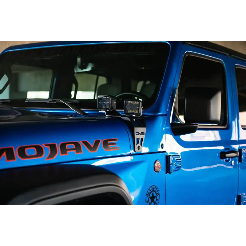 Blue Jeep with DV8 Offroad Dual Pod Light Mounts.