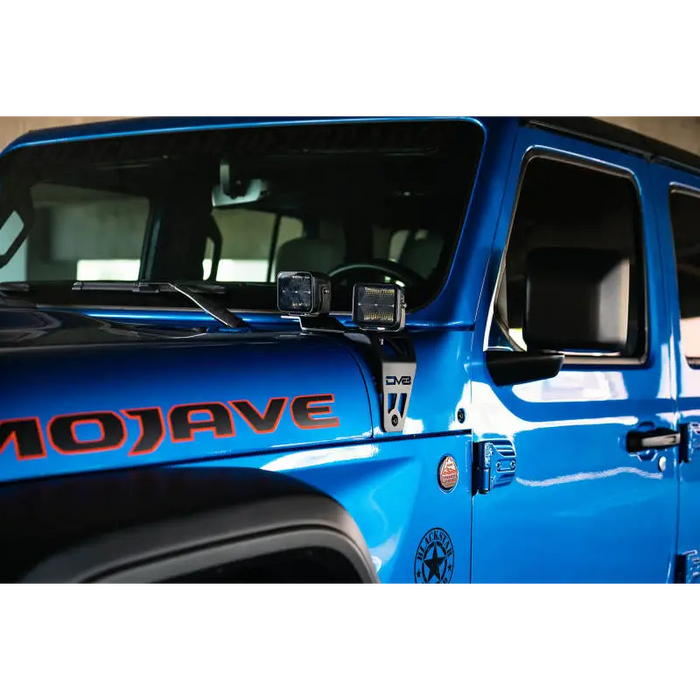 Blue Jeep with DV8 Offroad Dual Pod Light Mounts.