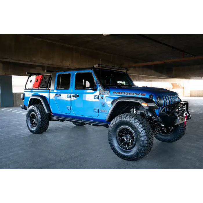 Blue Jeep with black and red bumpers - DV8 Offroad A-Pillar Light Bar Mount.