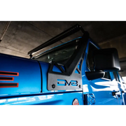 Blue truck with black door handle parked next to DV8 Offroad A-Pillar Light Bar Mount.