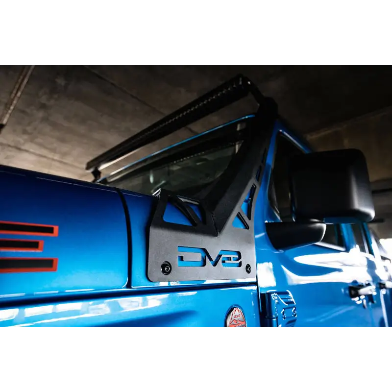 Blue truck with black door handle parked next to DV8 Offroad A-Pillar Light Bar Mount.