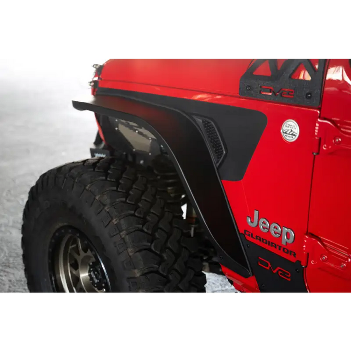 Red Jeep with black tire cover featuring DV8 Offroad 20-23 Jeep Gladiator JT Slim Fender Flares