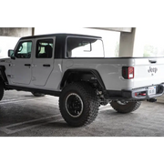 DV8 Offroad Jeep Gladiator JT Spec Series Fender Flares parked in parking lot adjacent to white truck