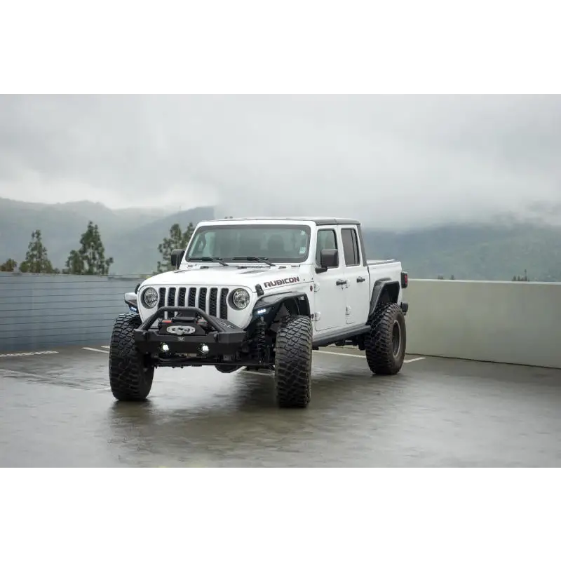 DV8 Offroad 20-23 Jeep Gladiator JT Spec Series Fender Flares parked in lot with mountains