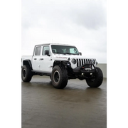 White Jeep Gladiator JT with a large tire on DV8 Offroad Spec Series fender flares