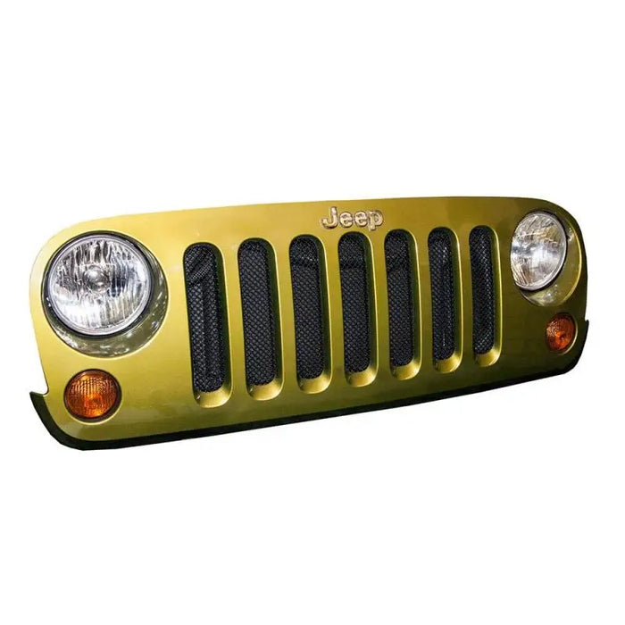 Close up of gold mesh grille on Jeep Wrangler with white background
