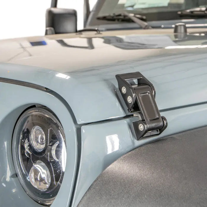DV8 Offroad 2007-2018 Jeep Rocklaw Hood Catch System - Light blue jeep with black bumper.