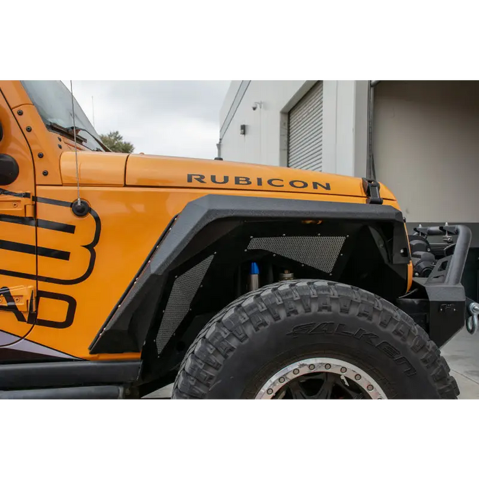 Yellow Jeep with black and white logo on DV8 Offroad armor style fenders