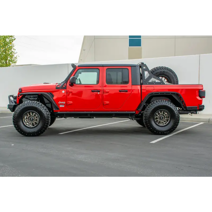 Red Jeep Gladiator with black bumper and wheels by DV8 Offroad.