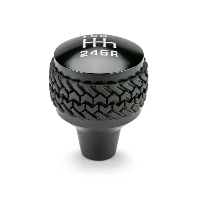 DV8 Offroad black shift knob with tire pattern for Jeep JK 6-Speed.