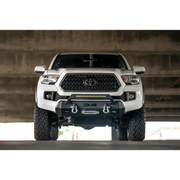 White Toyota Tacoma truck parked in garage - DV8 Offroad 2016+ Toyota Tacoma Center Bumper
