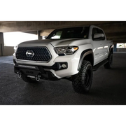 White Toyota Tacoma truck parked in DV8 Offroad 2016+ Toyota Tacoma Center Bumper.