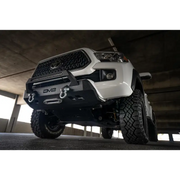 DV8 Offroad Toyota Tacoma Center Bumper: White truck parked in parking garage