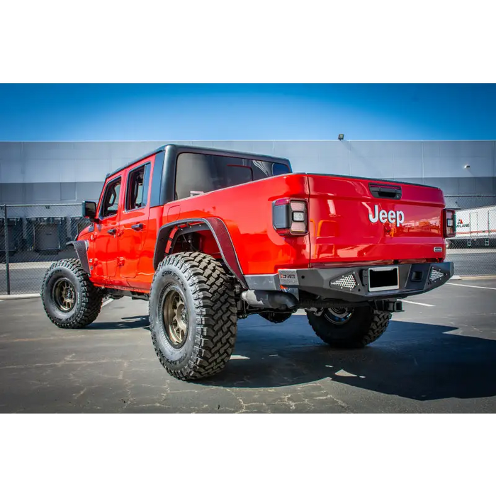 Red Jeep Gladiator rear bumper with big tire by DV8 Offroad