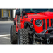 Red Jeep parked in parking lot with fence: DV8 Offroad 2018+ Jeep JL Fender Delete Kit