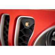 Red Jeep JL grill with black and white emblem and amber marker lights