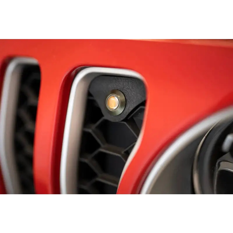 Red Jeep JL grill with black and white emblem and amber marker lights