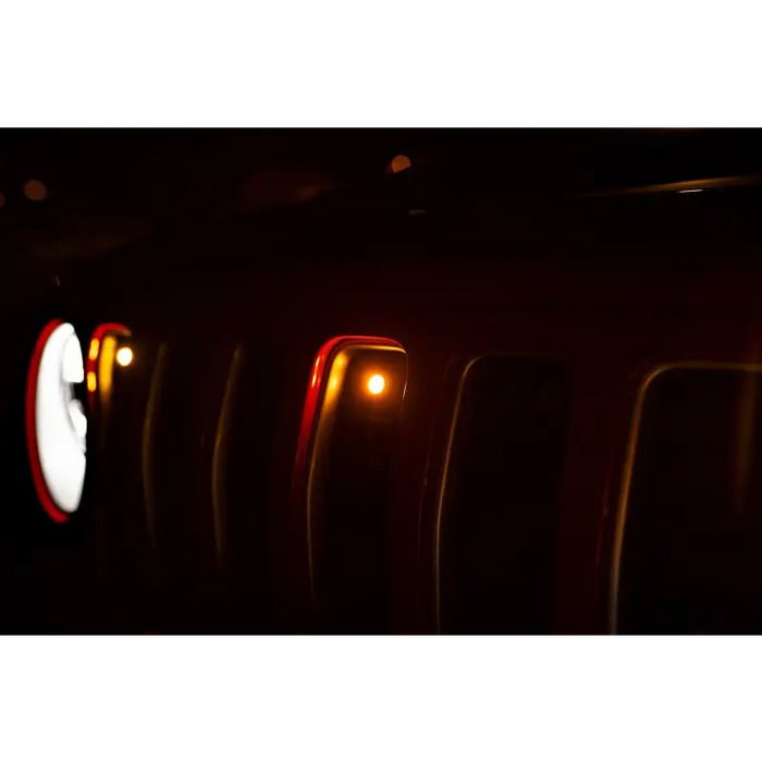 Interior of a car with lights on, showcasing DV8 Offroad 2018+ Jeep JL Grill Amber Marker Lights