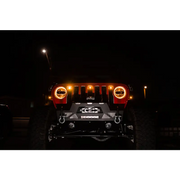 Close up of Jeep JL grill with amber marker lights on at night