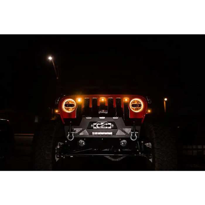 Close-up of Jeep JL grill with headlights on, showcasing DV8 Offroad 2018+ Amber Marker Lights