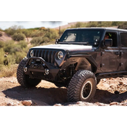 DV8 Offroad Jeep Wrangler JL parked on rocky trail.