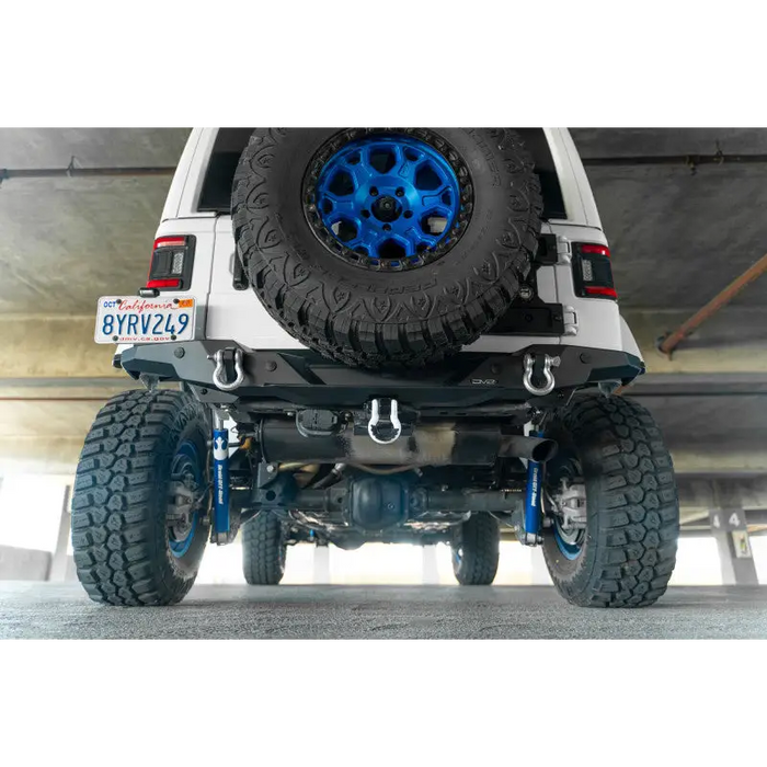 White Jeep Wrangler rear bumper with blue wheels and tires