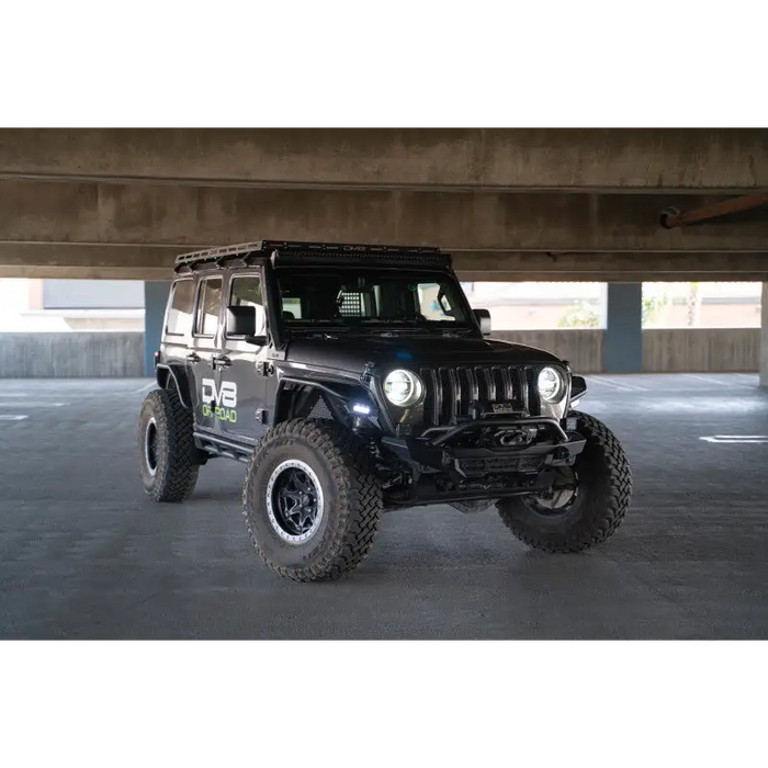 DV8 Offroad 2018+ Jeep Wrangler JL Light Bar Mount in a parking garage.