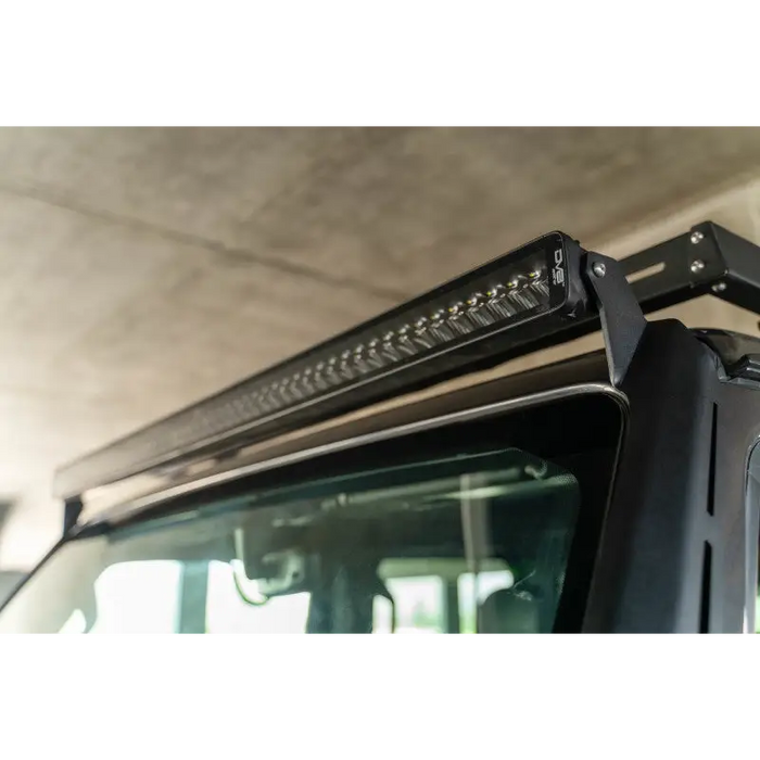 Black truck with light bar on roof, DV8 Offroad 2018+ Jeep Wrangler JL Light Bar Mount.