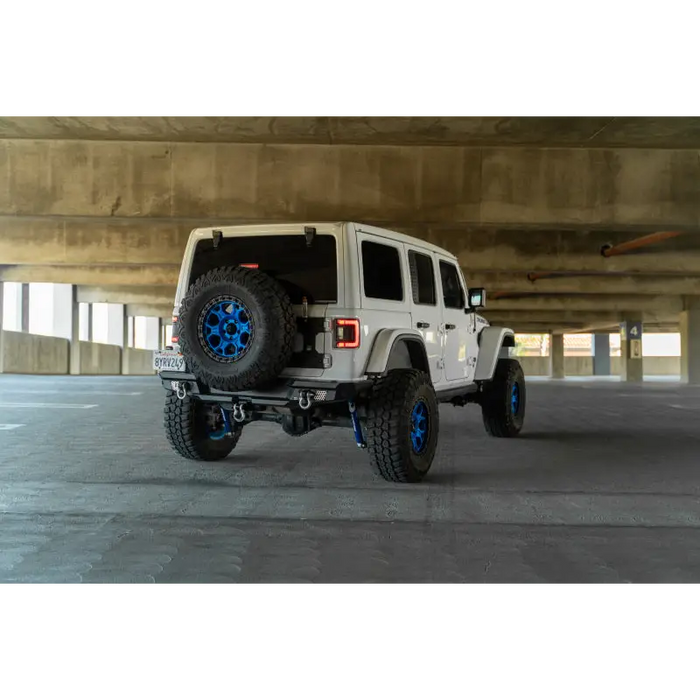 White jeep with blue wheels and tires on DV8 Offroad 2018 Jeep Wrangler JL MTO Series Rear Bumper.