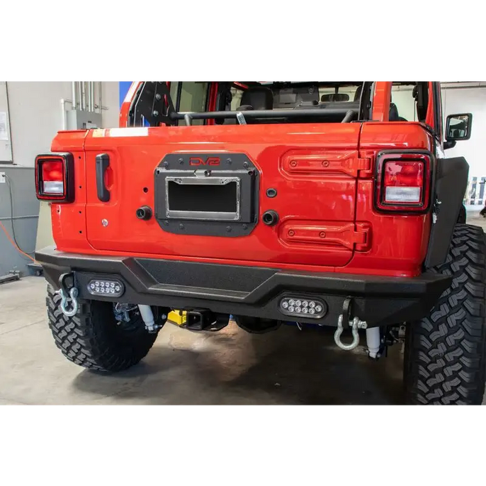 Red jeep with black bumper and spare tire delete kit
