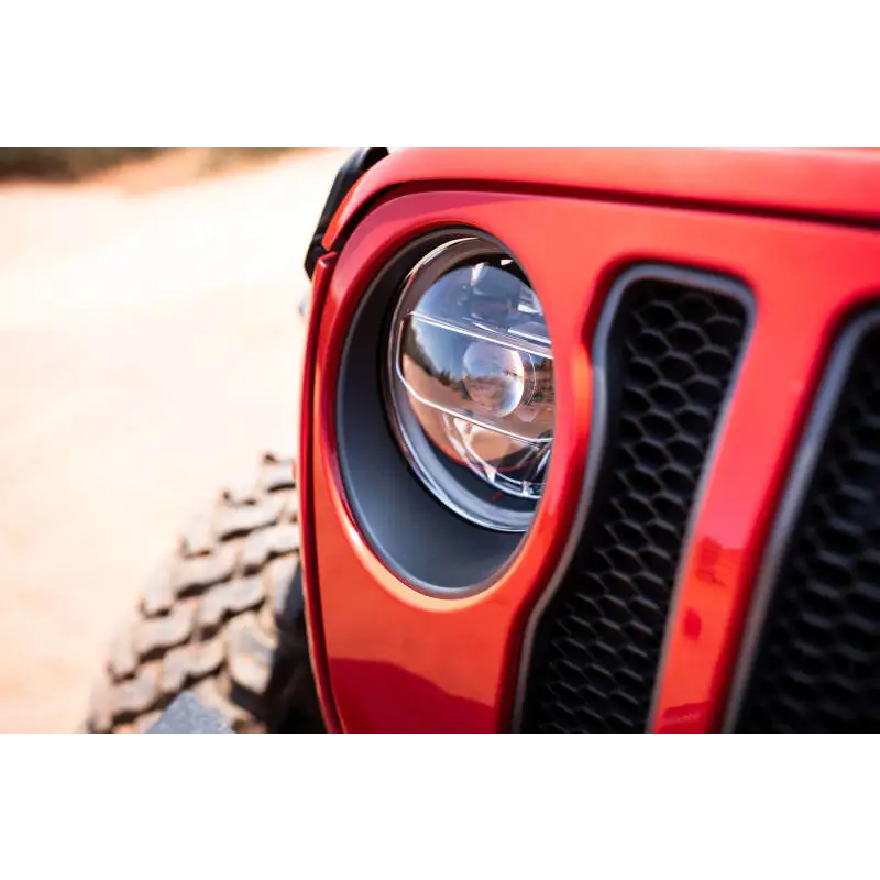 DV8 Offroad red Jeep Wrangler JL/Gladiator LED projector headlights with black grille and light.