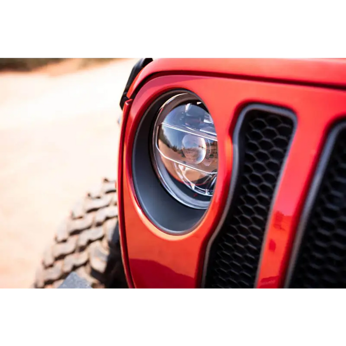 DV8 Offroad red Jeep Wrangler JL/Gladiator LED projector headlights with black grille and light.