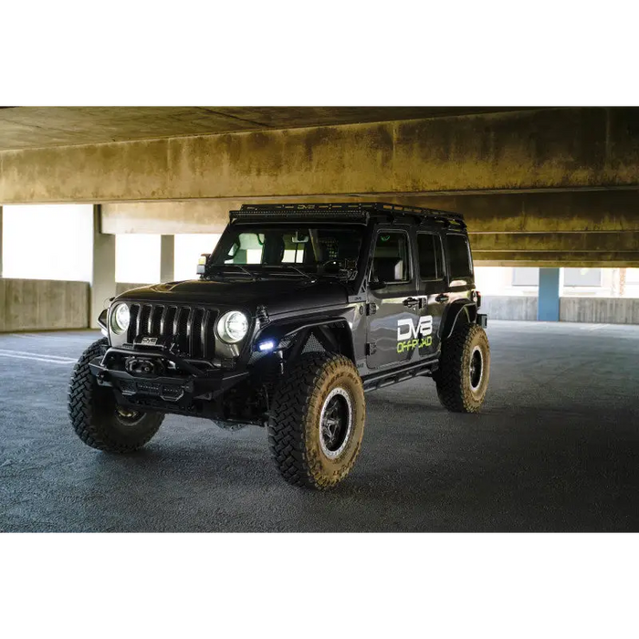 Jeep parked in parking garage with spacious area, showcasing DV8 Offroad 2018+ Jeep Wrangler JLO A Pillar Dual Light Pod Mounts