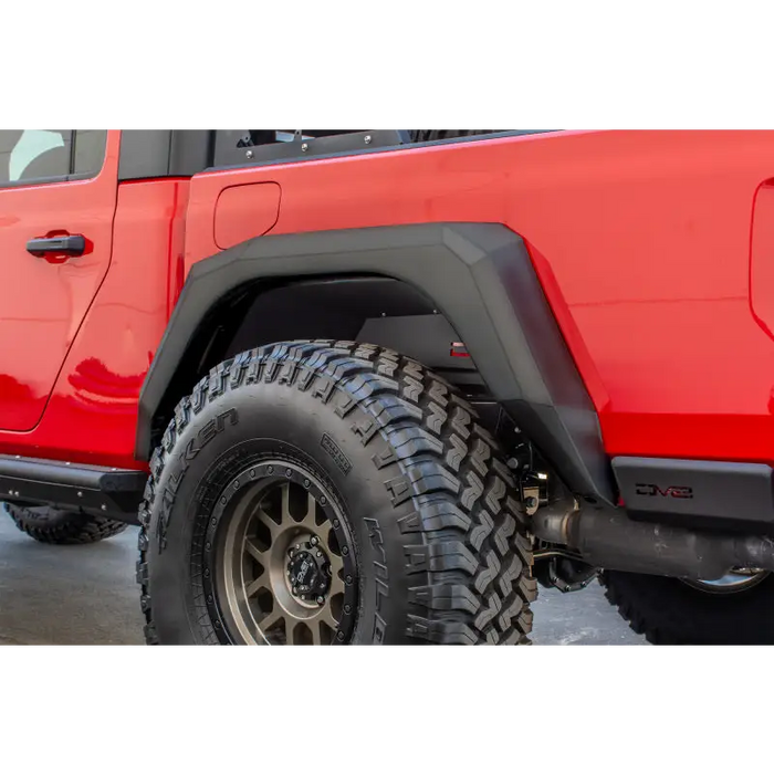 Red Jeep Gladiator with black bumper and tire cover - DV8 Offroad 2019+ Armor Fenders