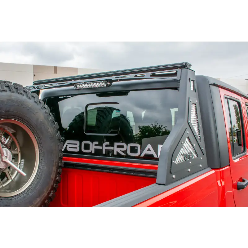 Red truck with black bumper and tire on DV8 Offroad Jeep Gladiator Bolt On Chase Rack