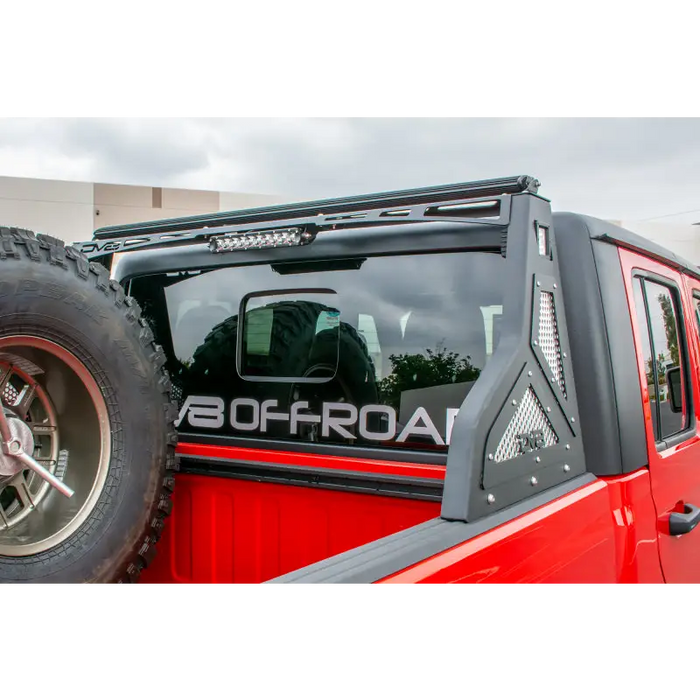 Red truck with black bumper and tire on DV8 Offroad Jeep Gladiator Bolt On Chase Rack