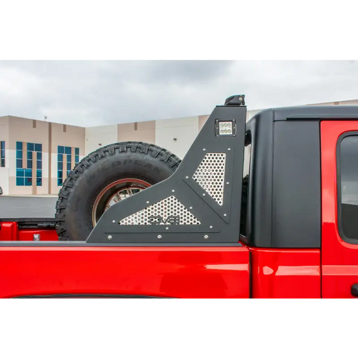 Red truck with black tire cover on DV8 Offroad 2019+ Jeep Gladiator Bolt On Chase Rack