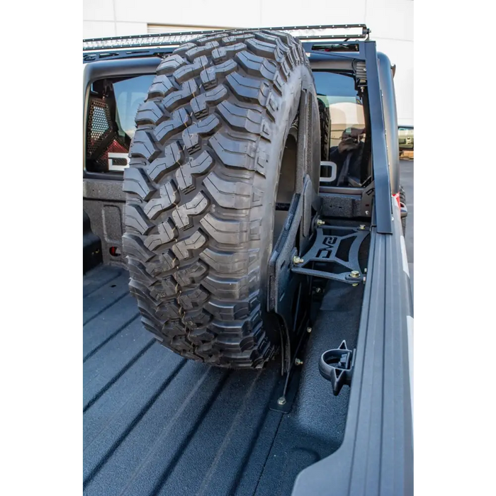 DV8 Offroad in-bed tire carrier with large tire