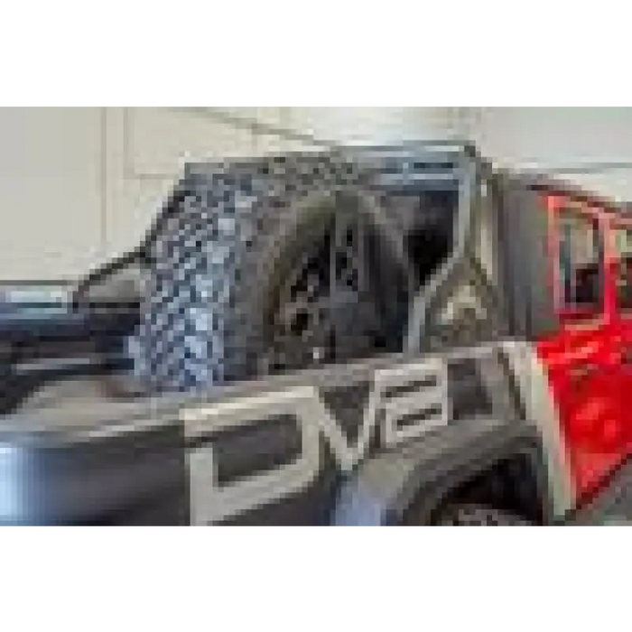 DV8 Offroad red Jeep Gladiator tire carrier in garage