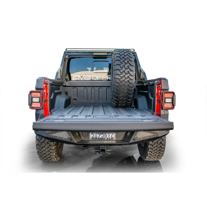 DV8 Offroad 2019+ Jeep Gladiator Universal Stand Up In-Bed Tire Carrier with rear bumper.onView