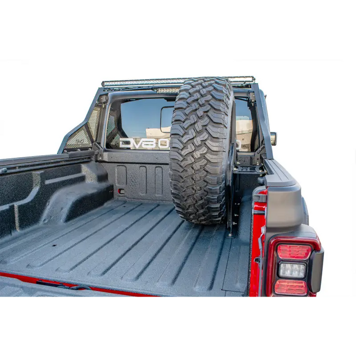 DV8 Offroad 2019+ Jeep Gladiator Universal Stand Up In-Bed Tire Carrier with open bed cover