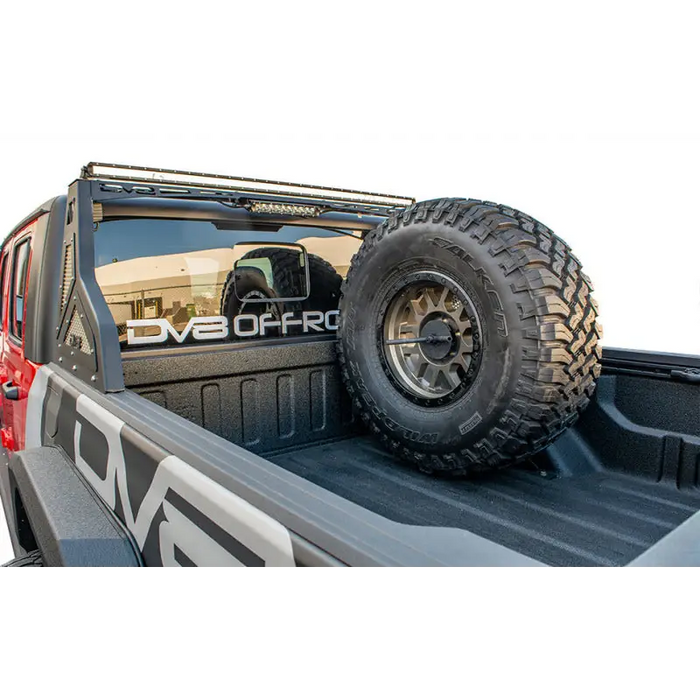 DV8 Offroad universal tire carrier for truck with large tire on bed