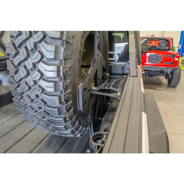 DV8 Offroad 2019+ Jeep Gladiator Universal Stand Up In-Bed Tire Carrier with front tire flat