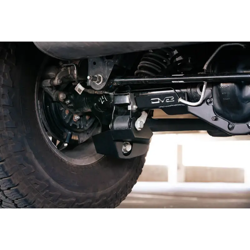 Close up of vehicle tire and wren on DV8 Offroad 2021-2022 Ford Bronco Rear Shock Guard Skid Plates.